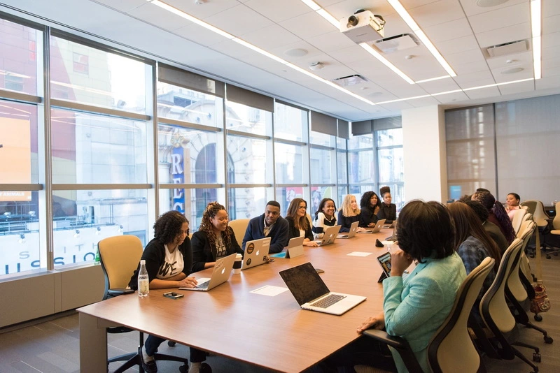 black women at work conference table microaggressions